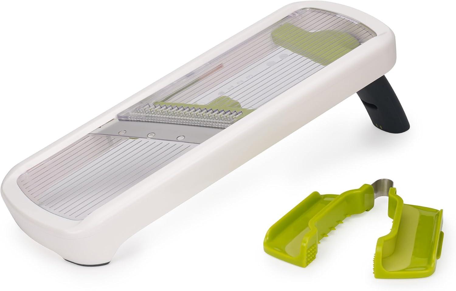 White kitchen mandoline slicer with green julienne guides and safety feet