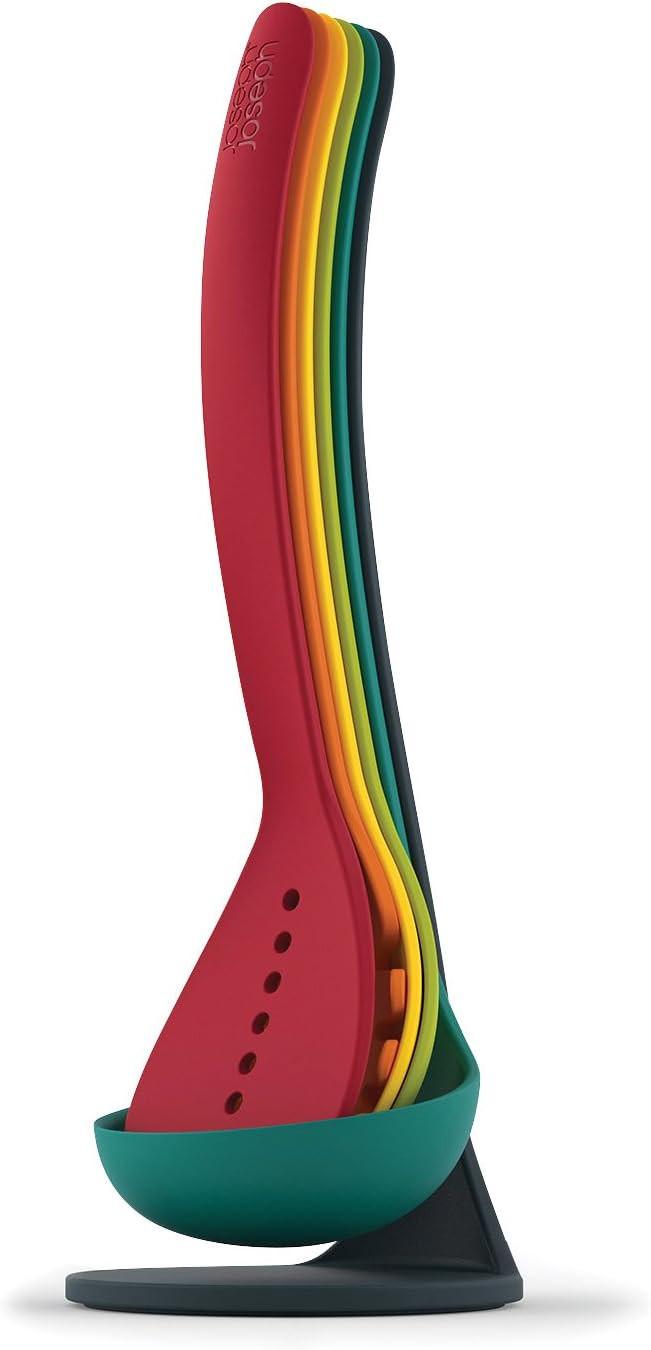 Multicolour kitchen utensil on a teal magnetic stand, with red silicone head and rainbow stripe handle.