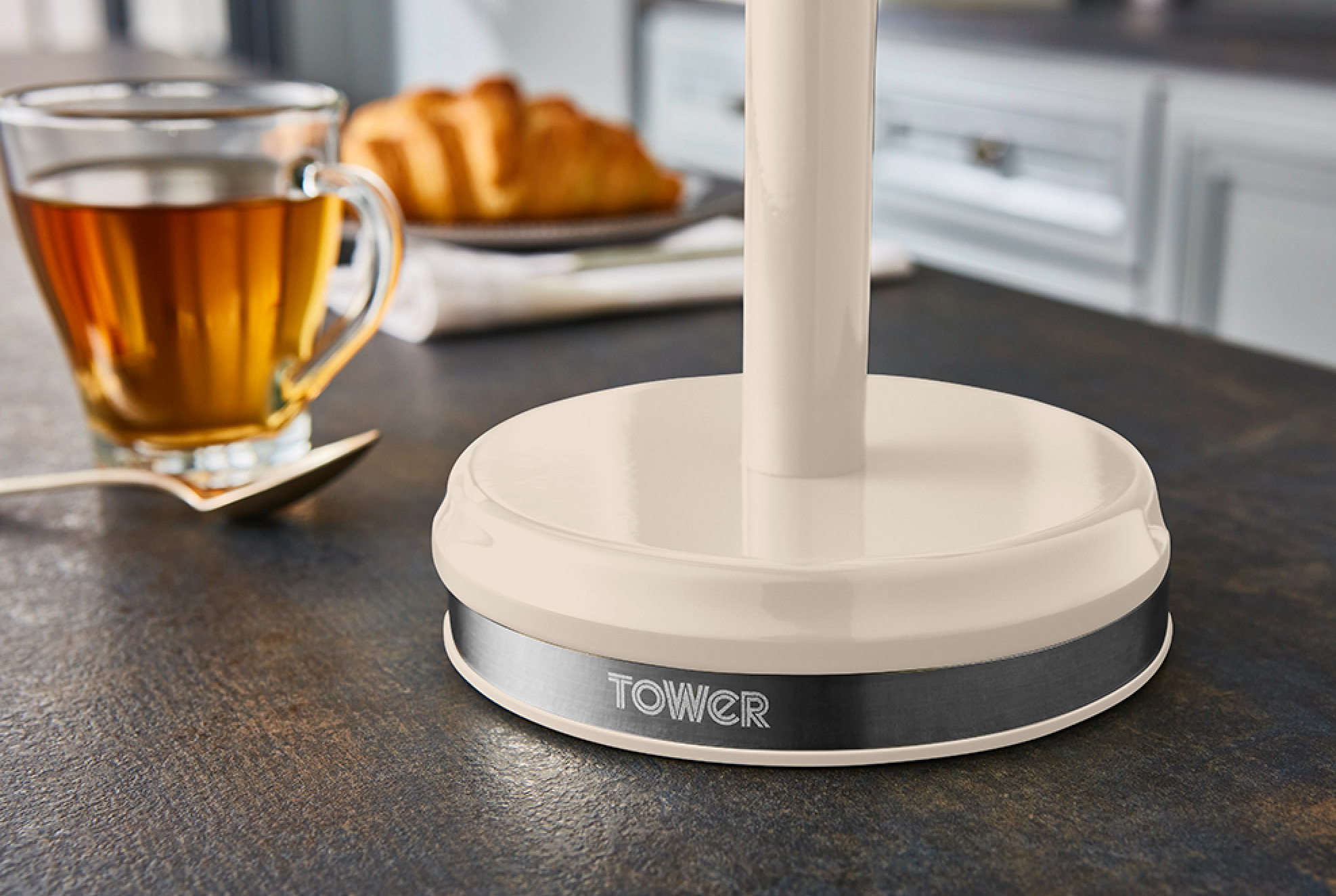 Cream base of mug tree stand with weighted black ring and TOWER logo
