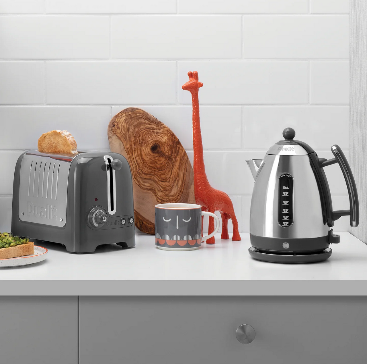 Grey 2-slice toaster on countertop with lever and side controls visible