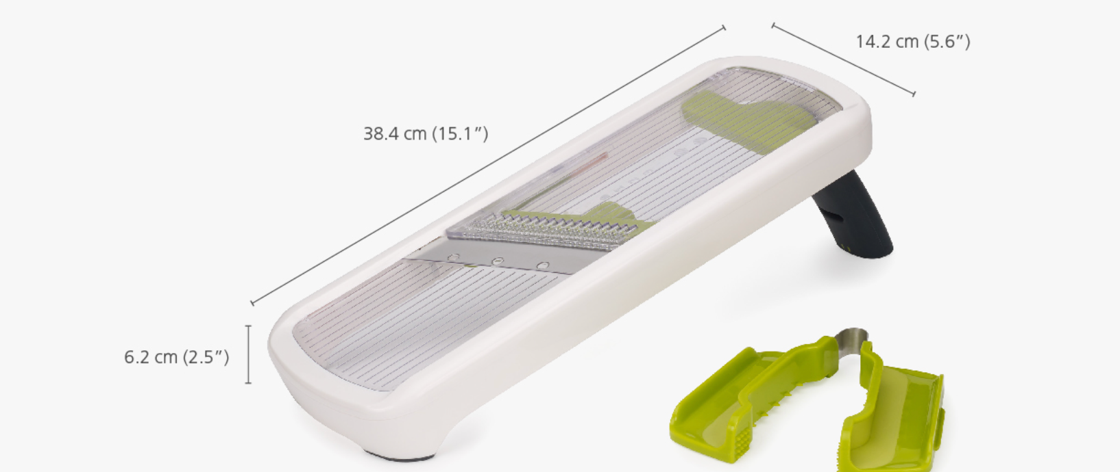 White kitchen mandoline with grating tray, green guard pieces, and black base feet