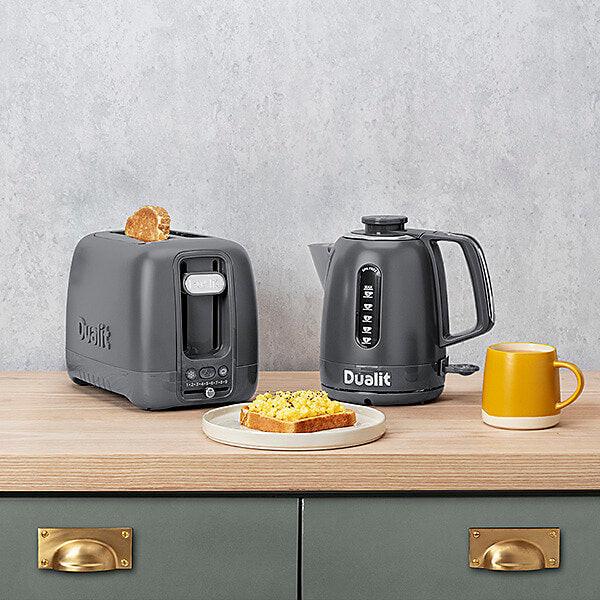 Grey 2-slice toaster on countertop with lever side and top slot visible