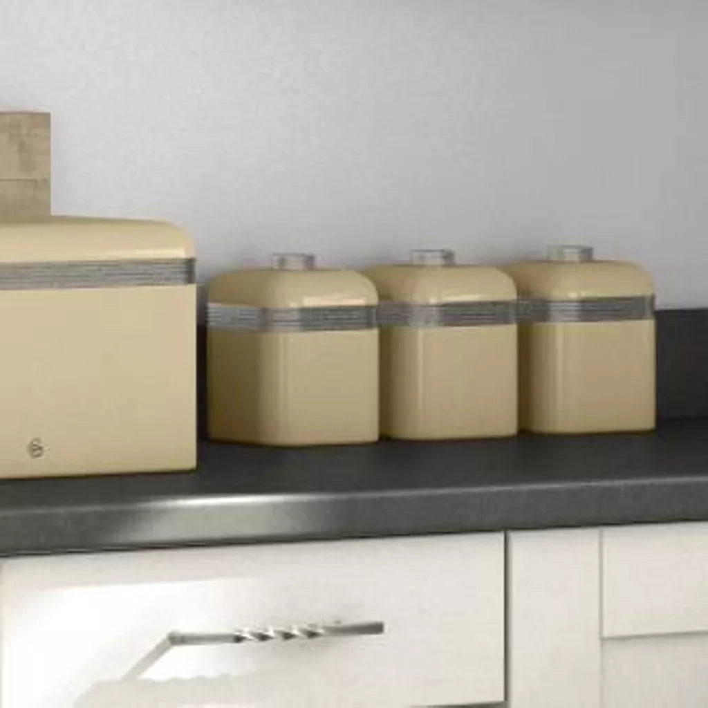 Cream kitchen storage canisters set with silver-lidded tops, staged on shelf