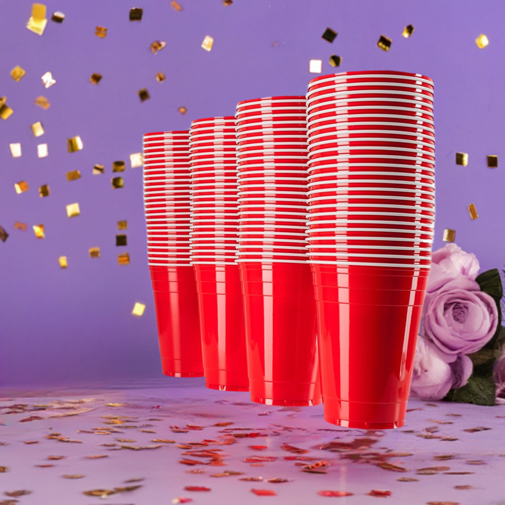 Stack of red plastic disposable party cups on a purple celebration background