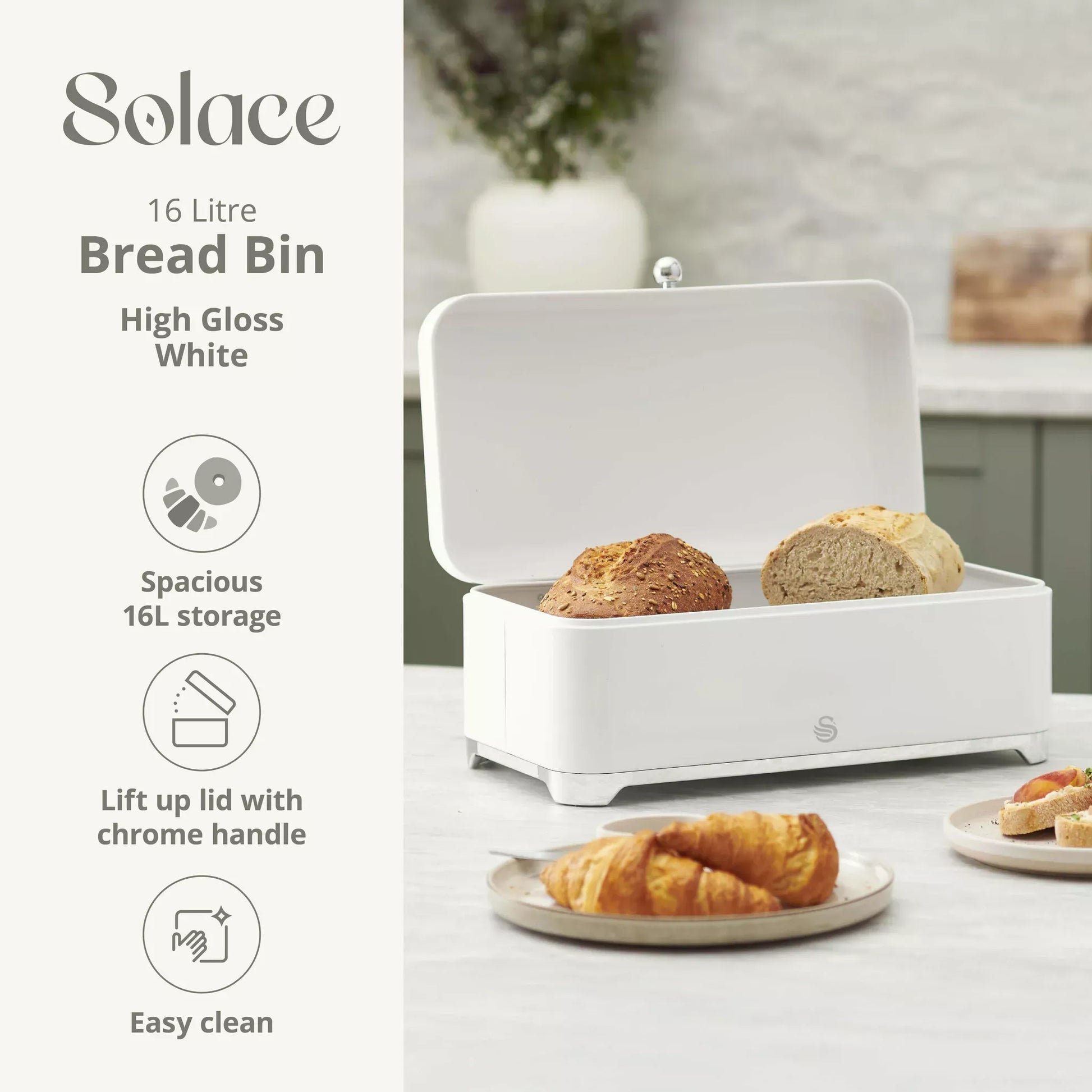 White high-gloss bread bin with open lid and chrome handle, holding loaves