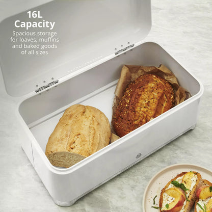 White bread bin with chrome-trim, open with two loaves inside
