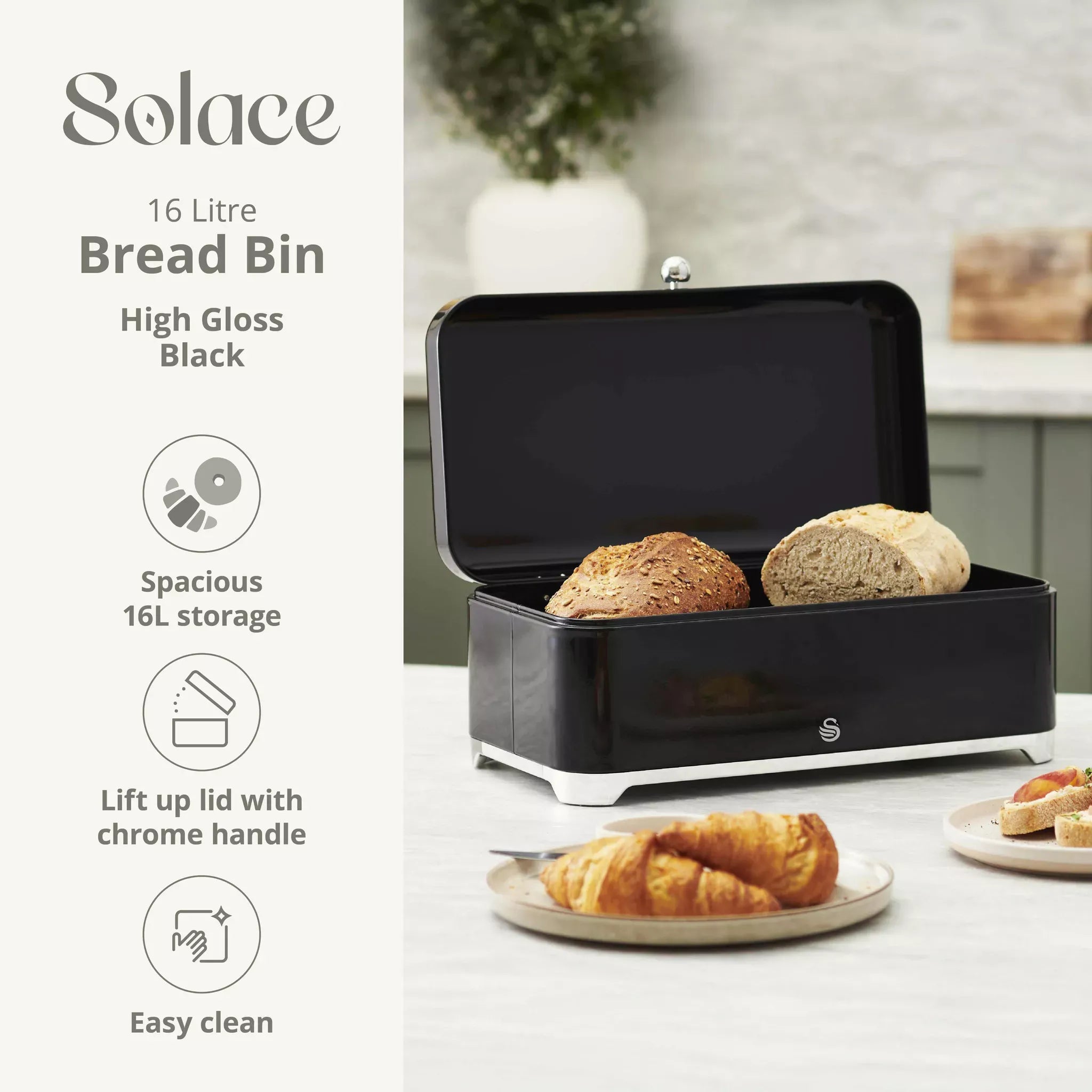 Black bread bin with lid open and chrome handle; holds bread slices in a storage tray