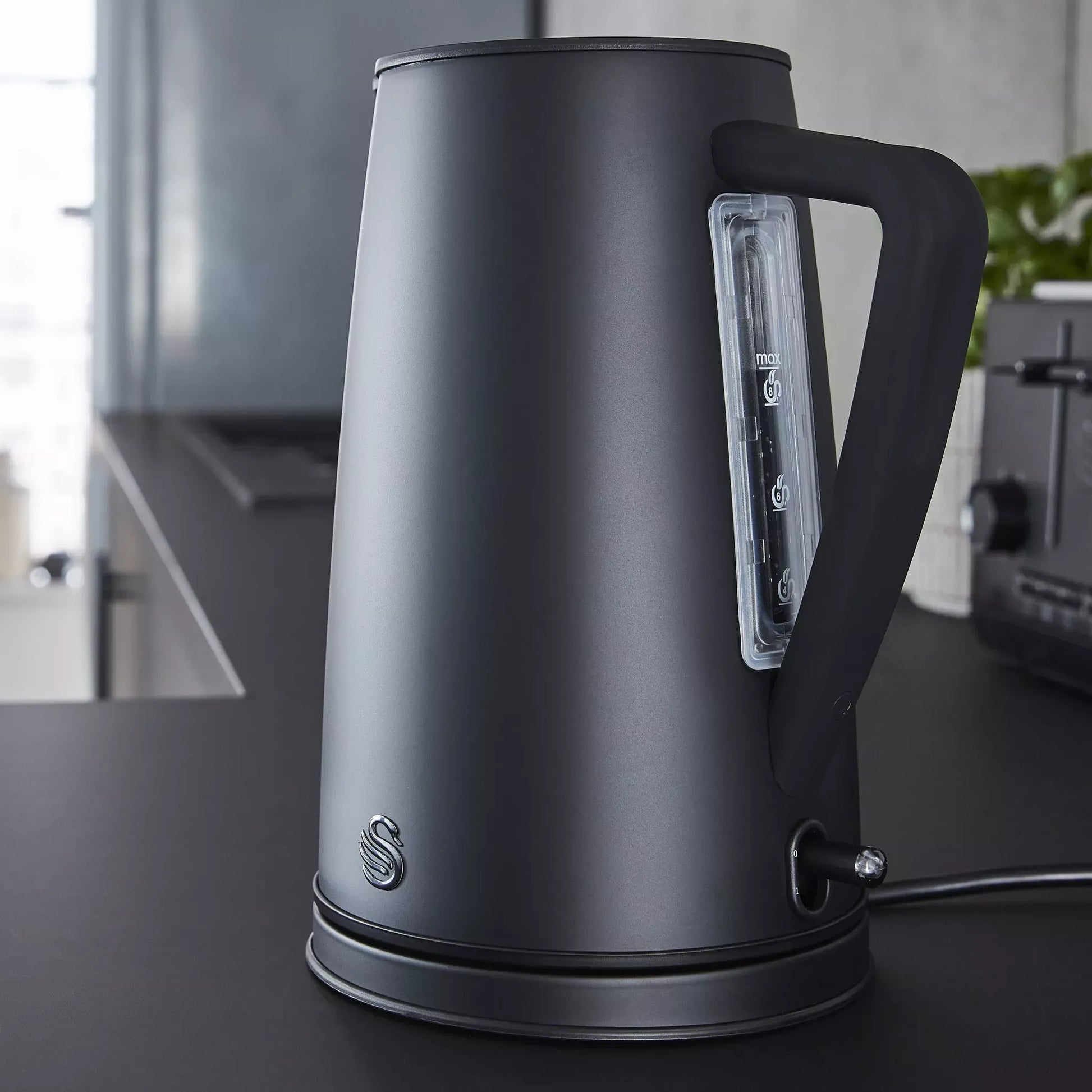 Matt black kettle with clear water level window and power base