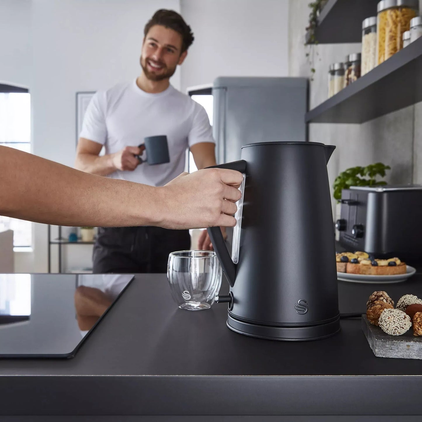 Matt black electric kettle on countertop with pouring spout