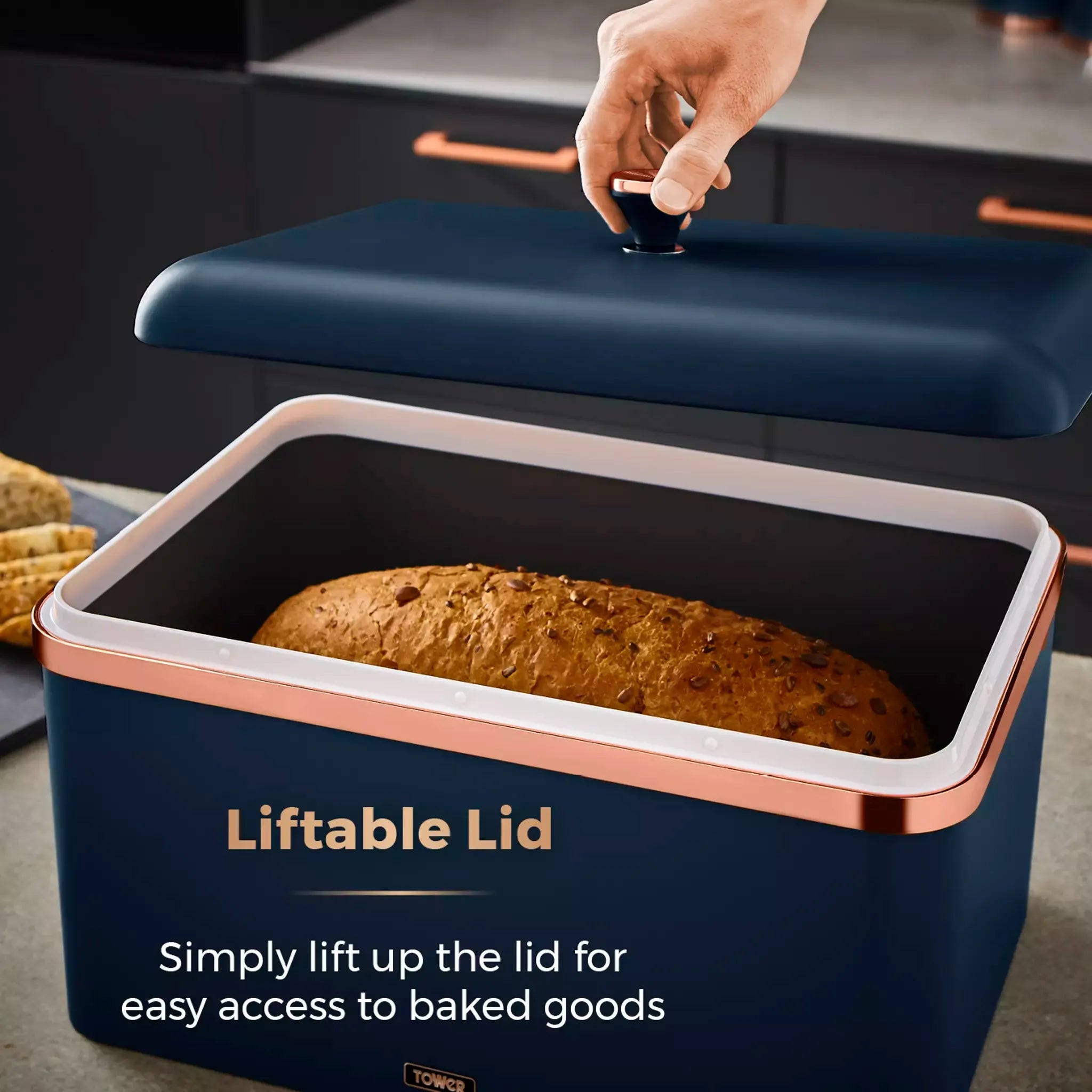 Midnight blue bread bin with liftable lid open, white tray insert, rose-gold trim