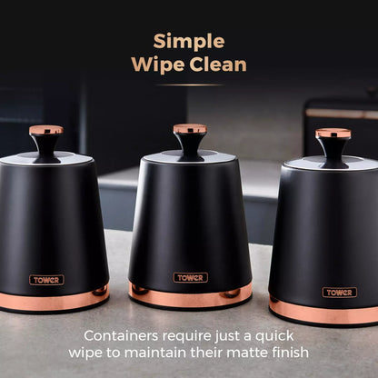 Three black storage canisters with round lids and copper bases