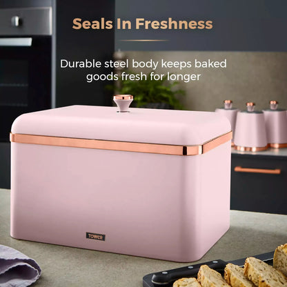Marshmallow pink bread bin with copper handle, closed lid; countertop storage for baked goods.