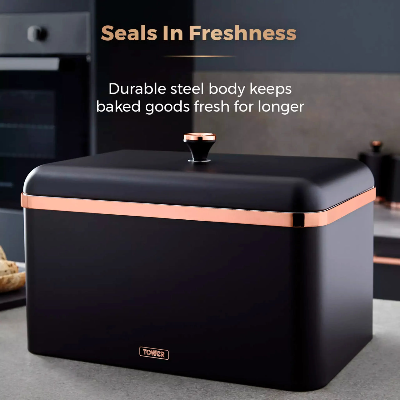 Black bread bin with rose-gold trim and upright knob handle