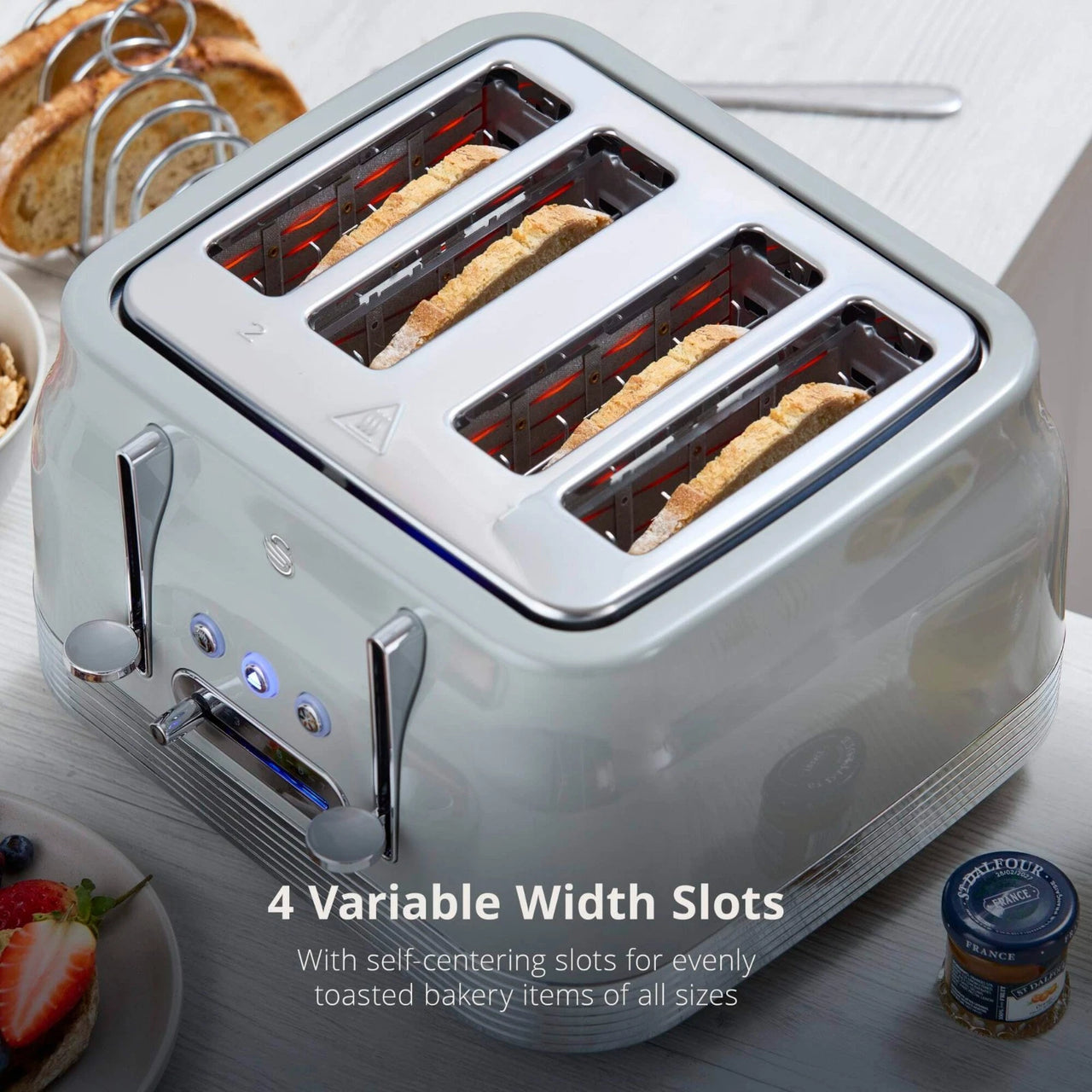 Grey retro 4-slice toaster showing four toasting slots with bread inside