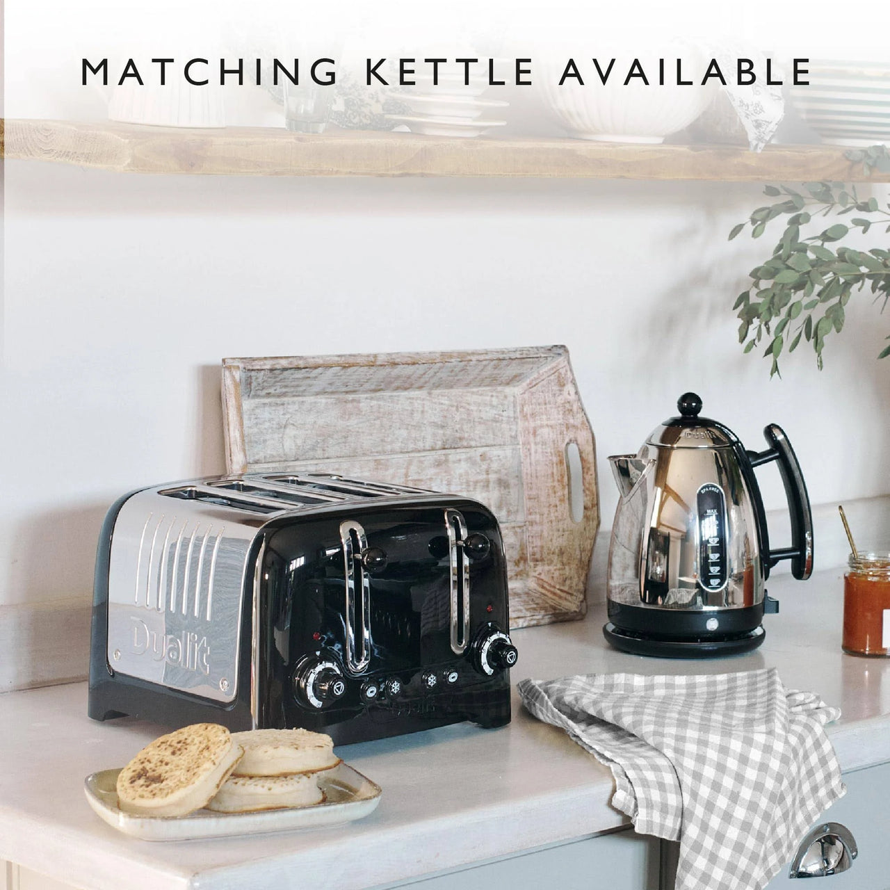 Black 4-slice toaster with stainless slots and front dials on a countertop