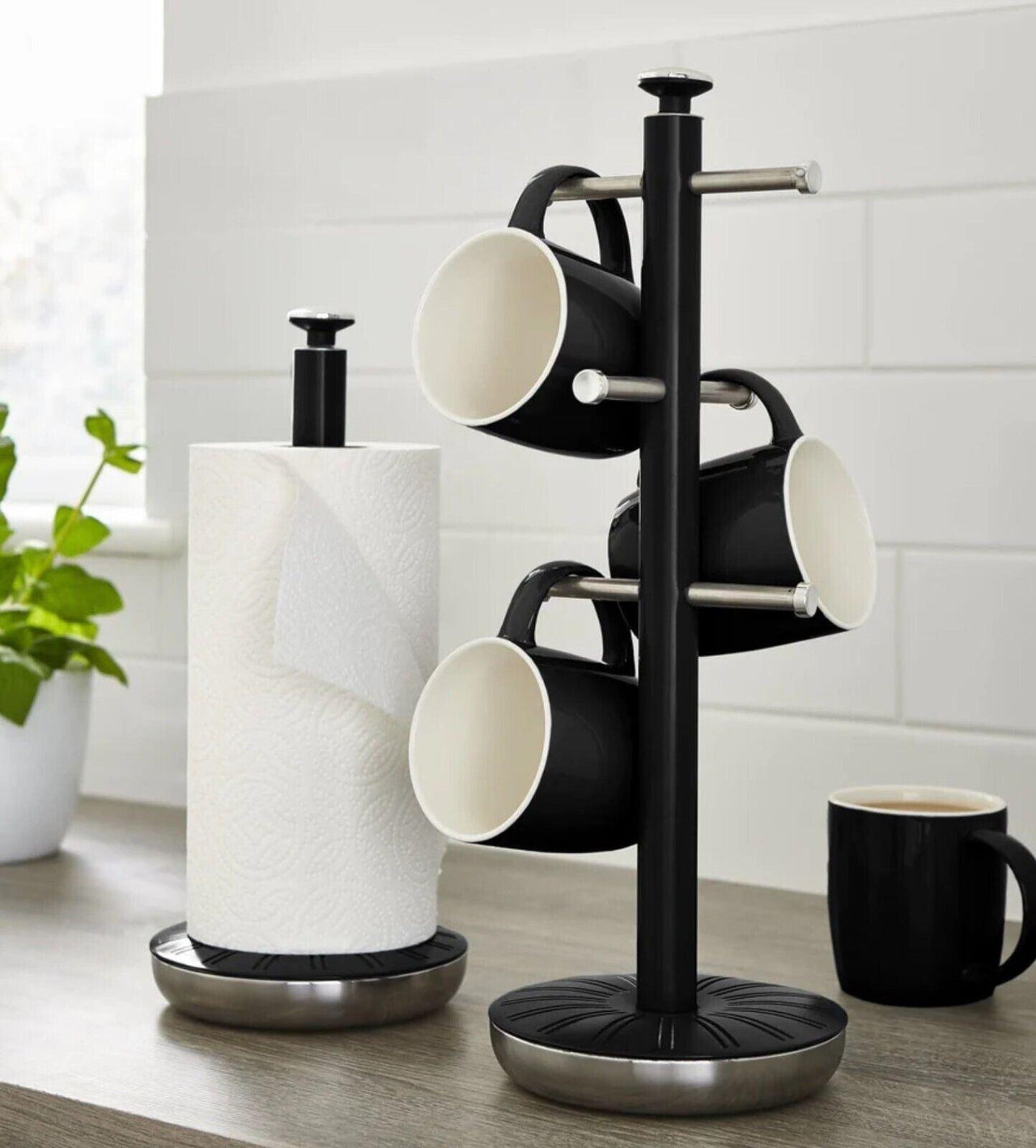 Black mug tree with paper towel holder, three mug hooks, and round base